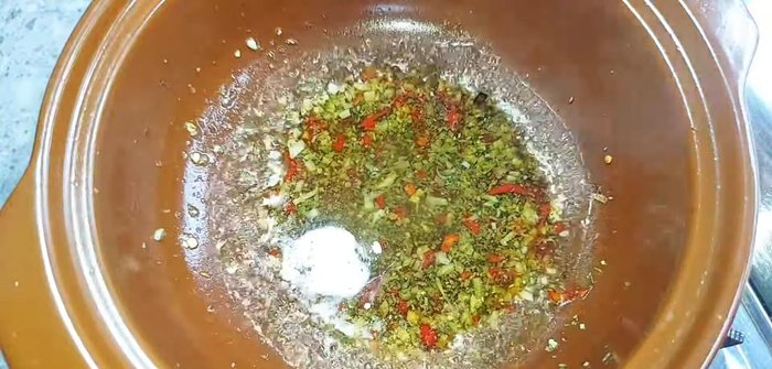 Add vegetarian fish sauce, vegetarian oyster sauce, chili sauce, sugar, and vegetarian seasoning to the pot. Stir well.