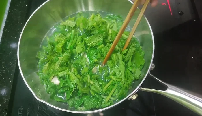 Add the prepared mustard greens to the pot.