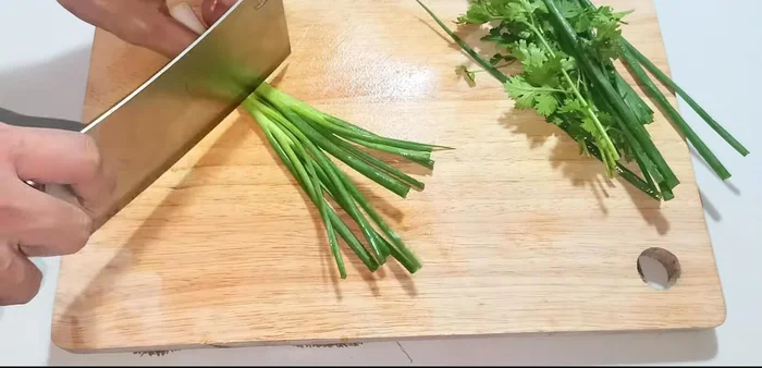 Finely chop the white part of the green onions.