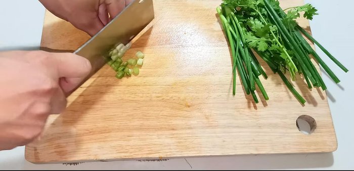 Saute the chopped green onions until fragrant.