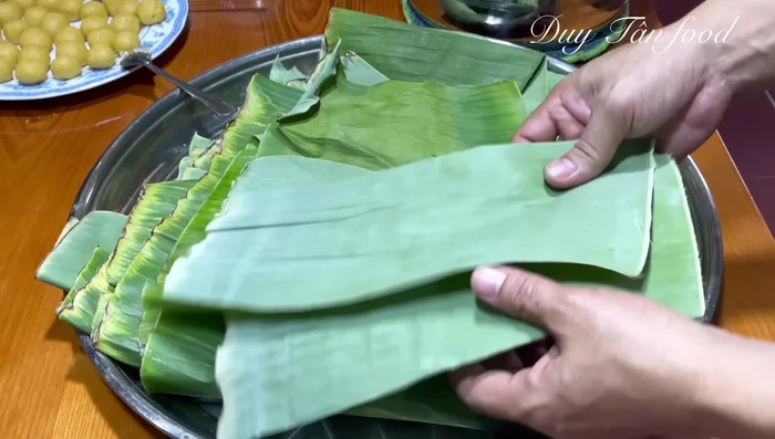 Prepare banana leaves: wipe clean or blanch in boiling water. Cut leaves into 12-15cm wide pieces. Brush with oil to prevent sticking.