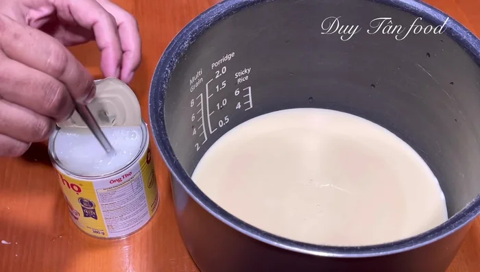 Add four cans of boiling water to the milk. Stir gently to dissolve the milk mixture.