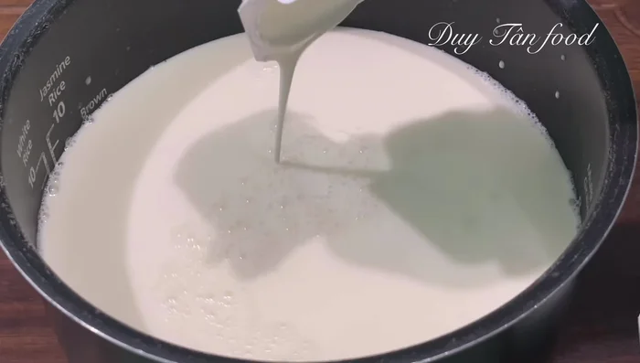 Add the yogurt starter (ensure it's at room temperature). Stir gently in one direction until fully incorporated.