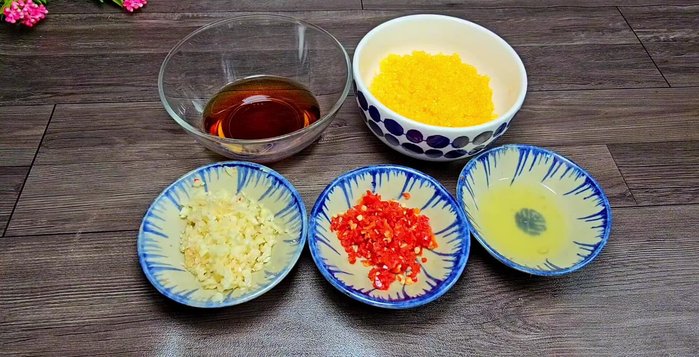 Prepare the sweet and sour fish sauce: Combine fish sauce, minced garlic, chili, lemon juice, brown sugar, and filtered water. Mix well and let it sit for 1 hour before serving.