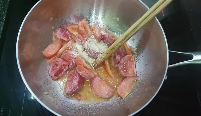 Simmer the tomatoes until soft.