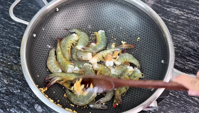 Fry the shrimp: Add shrimp to the pan with a little oil remaining from frying aromatics. Stir-fry over high heat until the shrimp turn bright red and firm.