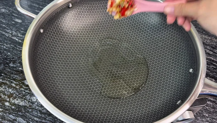 In a pot, fry the remaining onion, garlic and chili until fragrant. Add the tomatoes and cook until softened. Add the fish marinade, water, and simmer for 10 minutes.