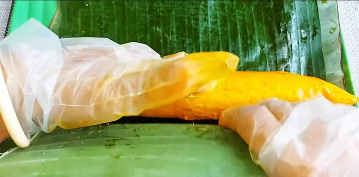 Wrap the rolled egg rolls tightly in banana leaves (or wax paper/aluminum foil). The tighter the wrap, the chewier and tastier it will be.
