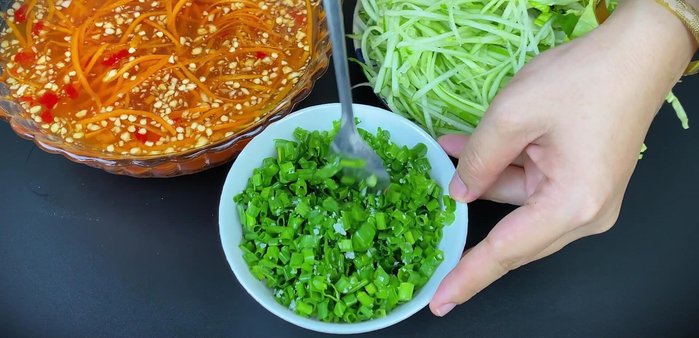 Make scallion oil: Mix chopped green onions with salt, then add hot oil.