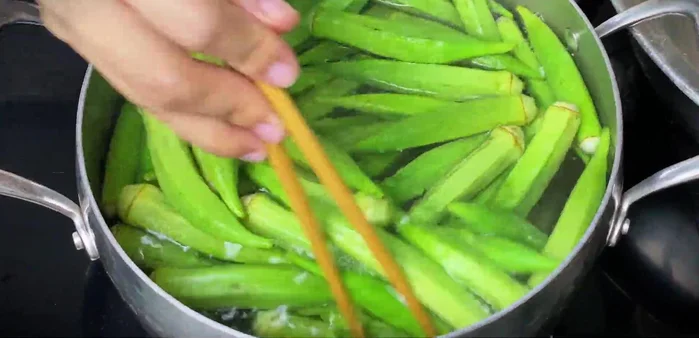 Blanch the washed okra in the boiling water until bright green. Immediately transfer to a bowl of ice water to maintain color.