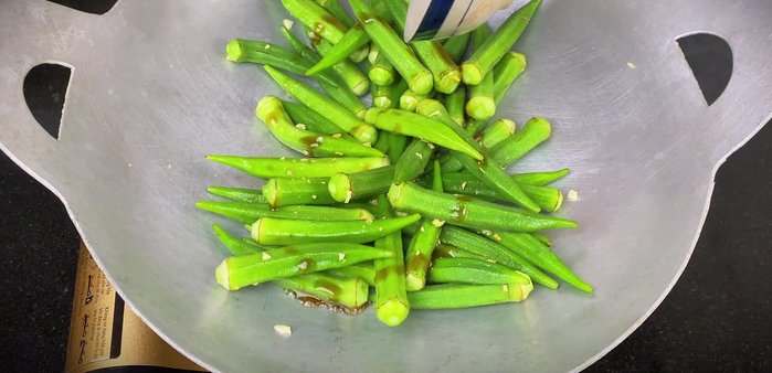 Pour in the mixed sauce and stir until the okra is well coated and the sauce is absorbed.