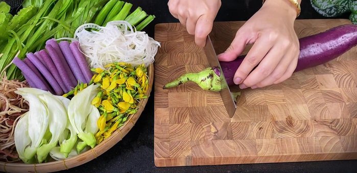 Prepare the vegetables: cut eggplant into pieces and soak in diluted salt water to prevent browning. Wash and drain other vegetables.