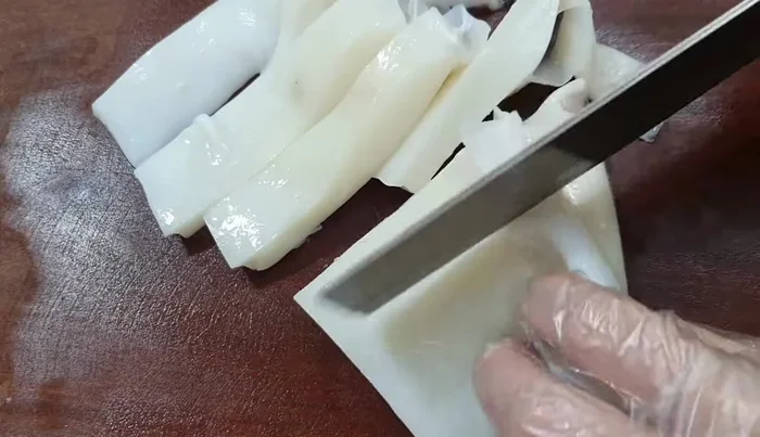 Cut the squid into small pieces for easy grinding.