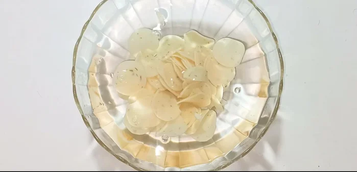 Soak shrimp crackers in water to soften.