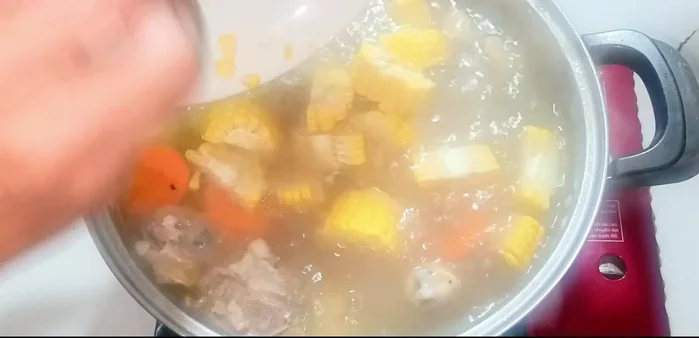Add carrots and corn. Add soaked lotus seeds and red dates.