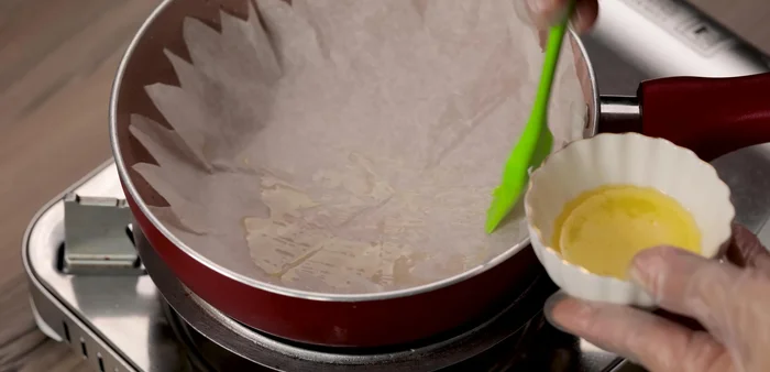 Grease the pan with butter or coconut oil and line it with parchment paper.