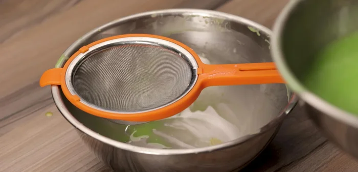 Sift the batter again through a fine sieve to ensure even distribution of baking powder.