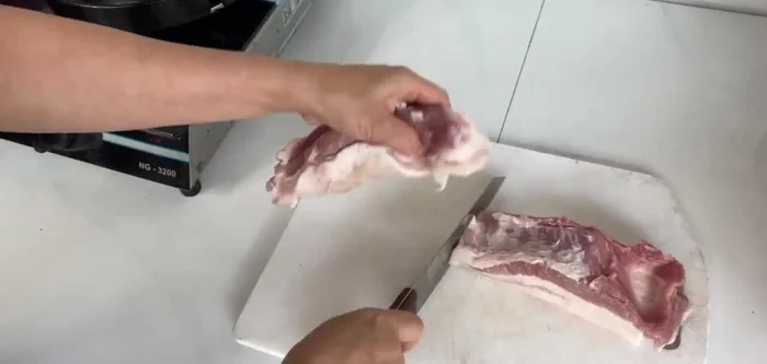 Cut the pork belly into portions: one for grilled pork rolls and one for the banh bot loc filling.