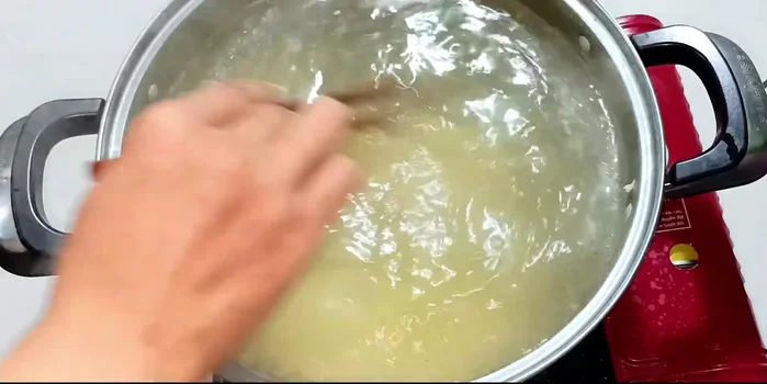 Add the roasted rice to the pot and stir well. Bring to a boil, then reduce heat and simmer, stirring occasionally to prevent sticking.