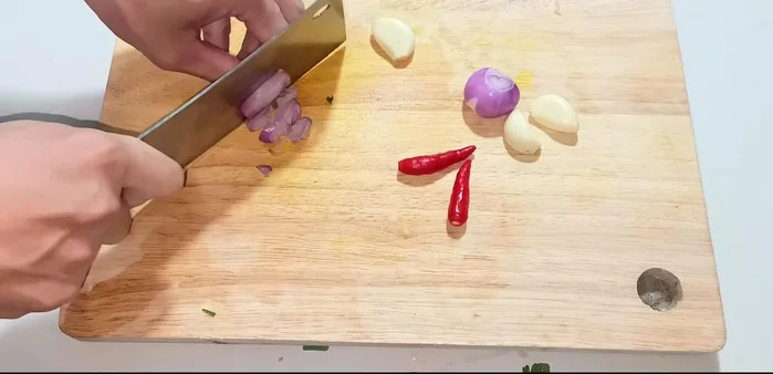 Chop shallots, garlic, and chili peppers.