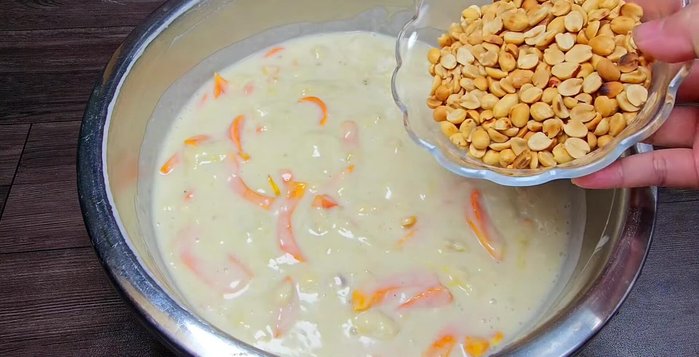 Add peanuts and mix again: Add the pre-roasted peanuts and mix thoroughly.
