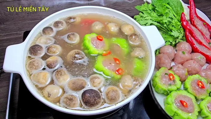Assemble the hot pot: Transfer the broth to a hot pot, add chili peppers and stuffed bitter melon. Cook until heated through. (405.919)