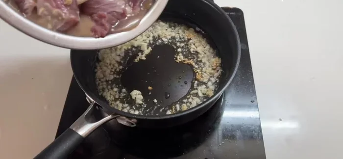 Add the beef to the pan and stir-fry until cooked.