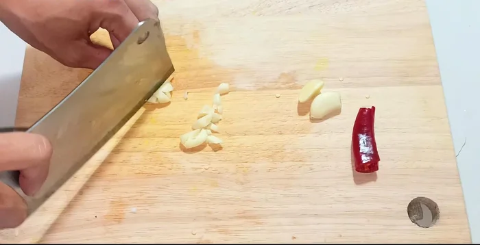 Mince garlic; use some for the salad, some for the fish sauce.