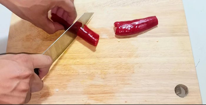 Cut chili peppers, removing seeds. Use some for the salad, some for the fish sauce.