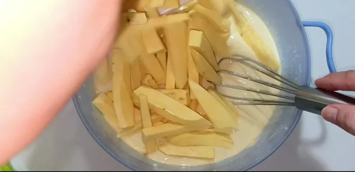 Coat the sweet potatoes: Add the sweet potato cylinders to the batter and mix well, ensuring each piece is evenly coated.
