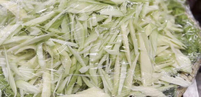 Prepare the papaya by peeling and shredding it using a grater or knife. Note: The level of shredding can adjust to your preferences.