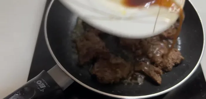 Add the water released from the beef earlier to the pan and cook for about 1 minute.