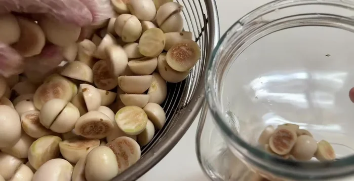 Pack the eggplant into a jar. Add the cooled fish sauce mixture, pureed garlic and chili.