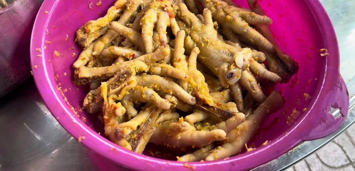 Marinate chicken feet with satay marinade. (This step is likely done beforehand)