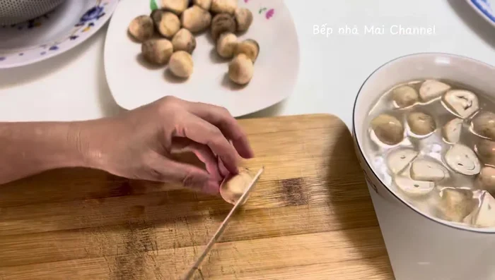 Soak straw mushrooms in salt water for 10-15 minutes, then wash and stir-fry them.