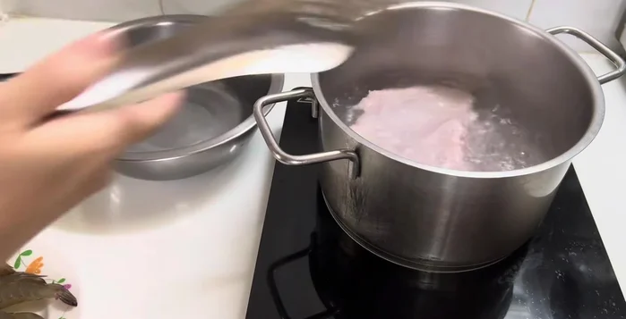 Boil the pork belly until cooked. Then transfer to cold water to keep it crispy.