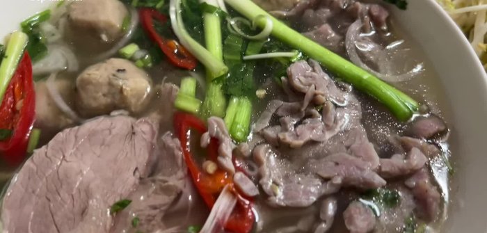 Prepare the ingredients: Rare beef, boiled beef, beef balls, onions, shallots, ginger, pho seasoning packet, pho noodles, bean sprouts, salt, sugar, MSG, pepper, coriander, cinnamon, lemon, and optional sauces.