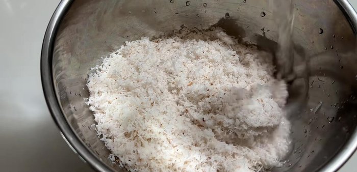 Mix warm water with the grated coconut. Ensure the coconut is fresh and fragrant; discard if it smells musty.