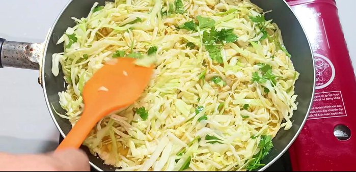 Press the cabbage down gently to ensure it sticks to the eggs.