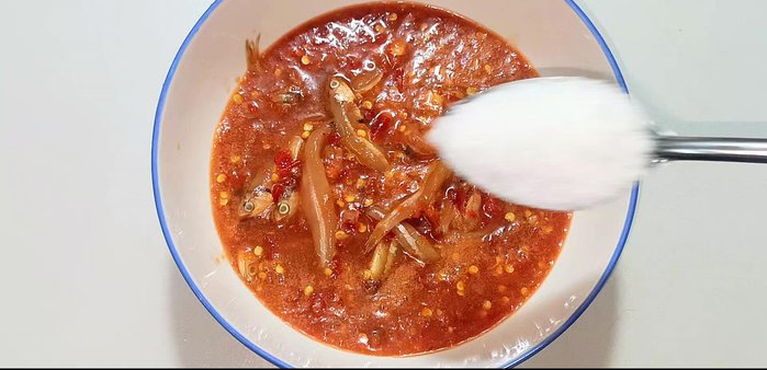 In a bowl, combine 400 grams of anchovy fish sauce, 4 tablespoons of sugar, and 1/3 tablespoon of MSG.