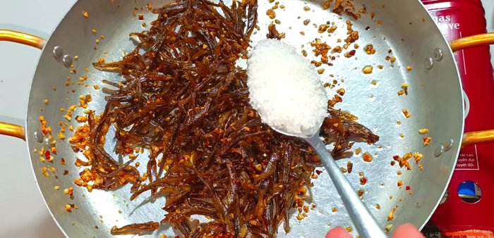 Add sugar, MSG (optional), fish sauce, and chili sauce. Stir gently to combine and avoid burning.