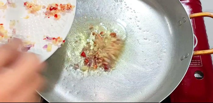 Heat oil in a pot over medium heat. Add the remaining minced garlic, shallots, and chili; fry until fragrant and golden brown.