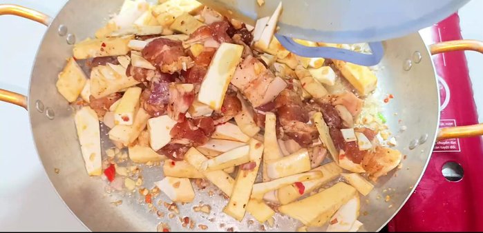 Add the marinated pork and coconut; stir-fry until the meat is firm and lightly browned.