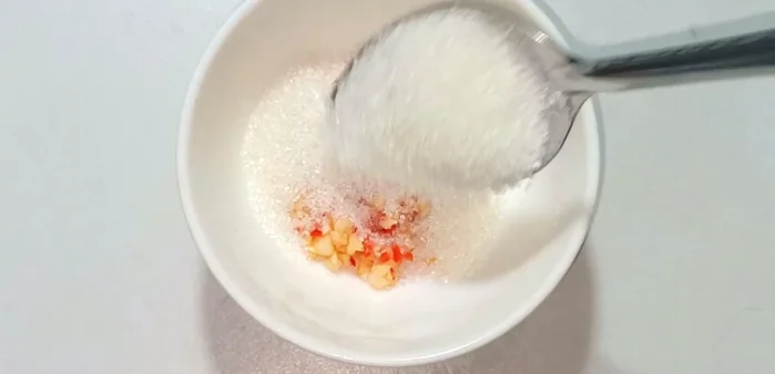 Prepare the dipping sauce: In a separate bowl, mix 2 spoons of sugar, 2 spoons of water, 2 spoons of fish sauce, 1 spoon of lemon juice, and 1 spoon of water. Stir until dissolved.