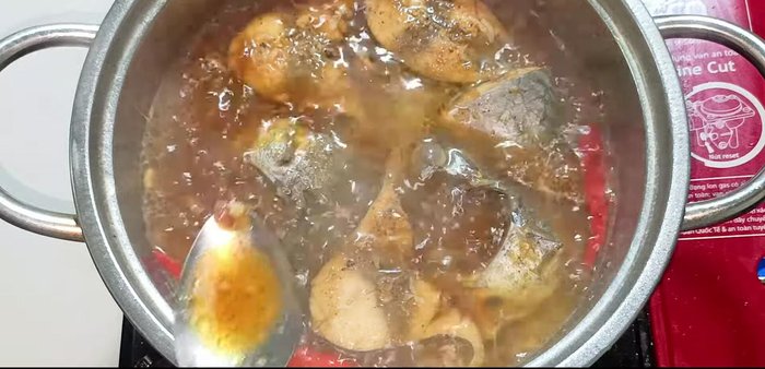 Season to taste. Flip the fish to ensure even coloring and absorption of braising liquid. Reduce heat to medium and continue braising.