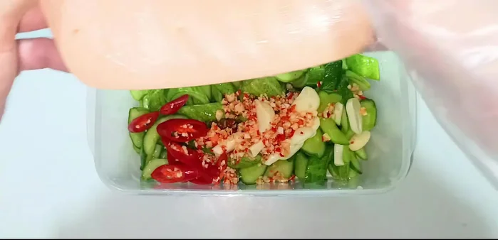 Add the garlic and chili to the fish sauce mixture once it has cooled completely. Add the cucumbers and let it soak for at least 5 hours, or overnight for a darker color and richer flavor.