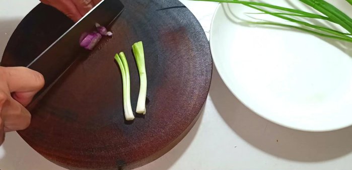 Chop the green and purple onions.