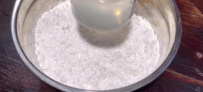 Add 350ml of warm water in 2-3 additions, stirring gently until well combined. Avoid kneading the dough; simply mix until all ingredients are incorporated. This process takes about 10-15 minutes.
