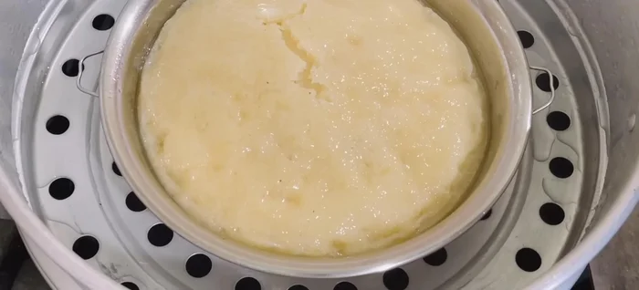 Check for doneness using a bamboo stick. If it comes out clean, the cake is ready. Let it cool slightly before removing from the mold.
