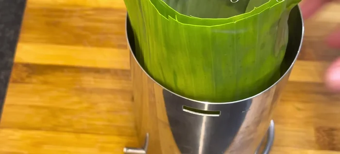Pack the mixture tightly into a mold lined with banana leaves. Press firmly to compact the meat. If using a large mold, do this in stages to ensure even packing.